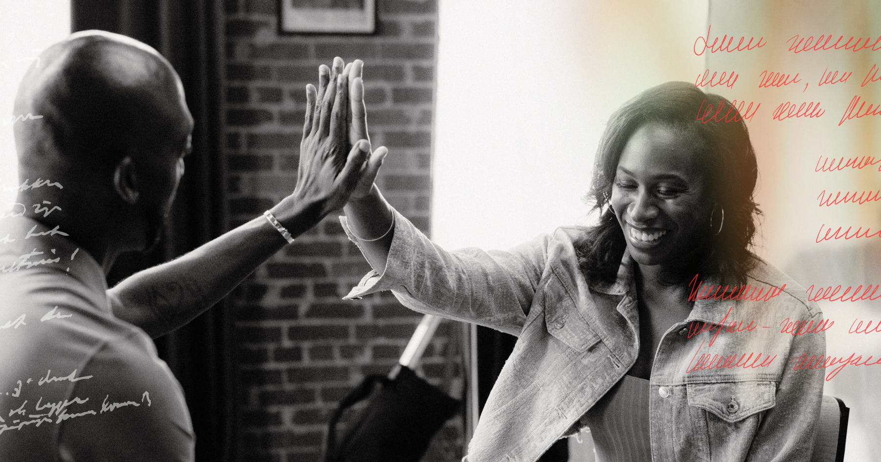 Picture of a black couple laughing and looking at each other with love while they high five each other