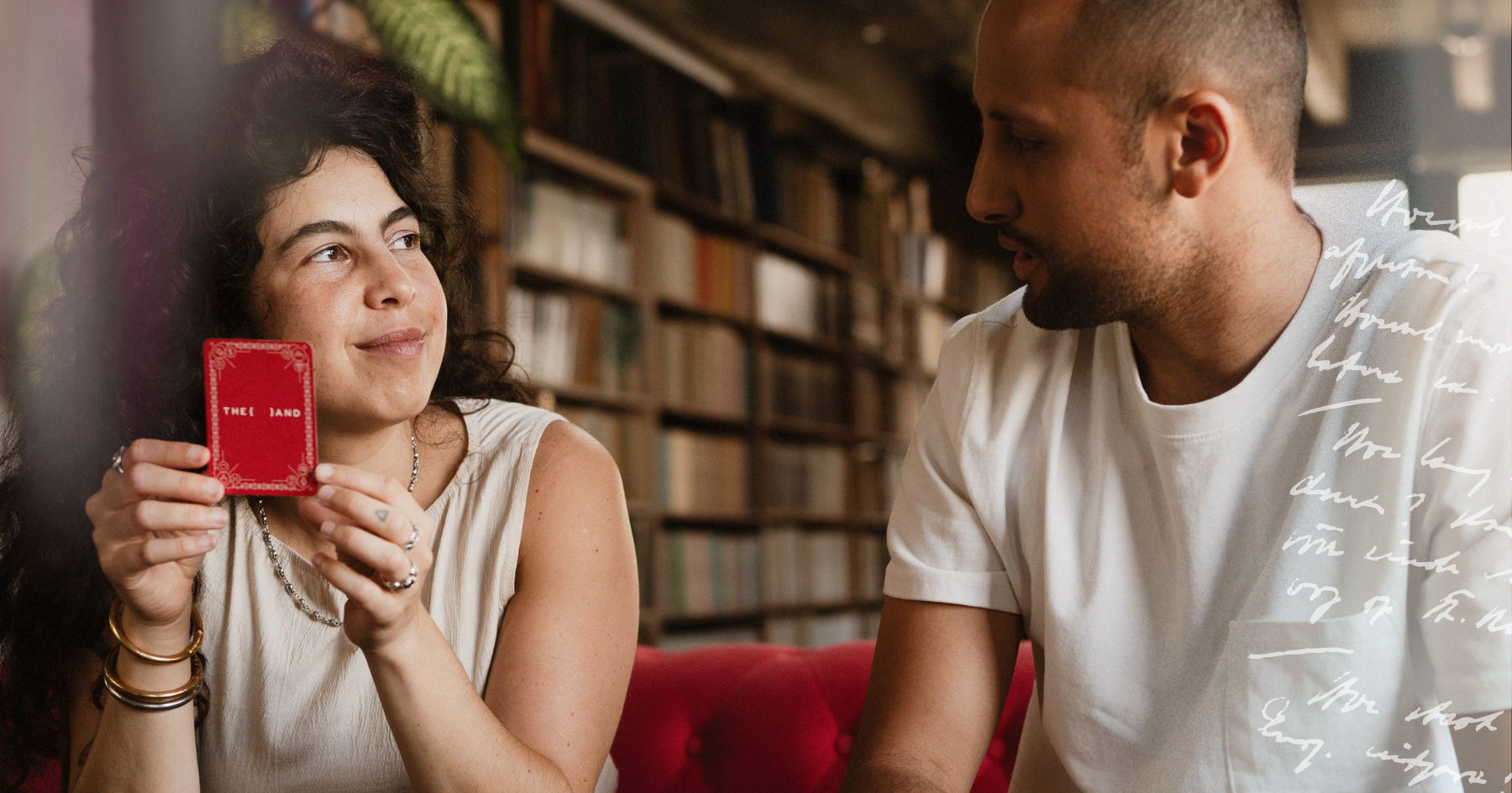 Picture of a couple holding a card from {THE AND} relationship card game and looking at each other in the eyes