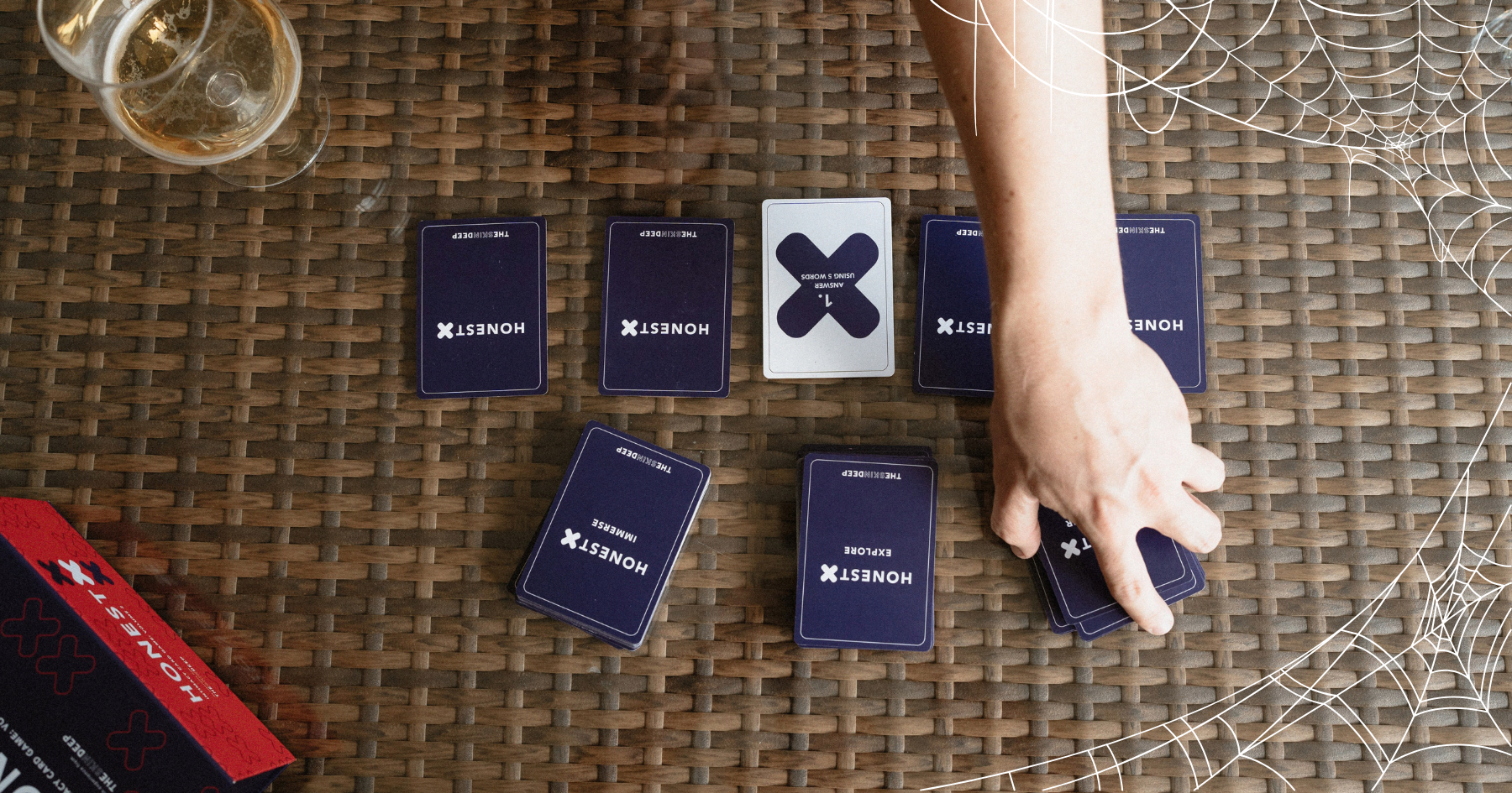 Picture of a hand grabbing cards from the Honest X intimacy card game