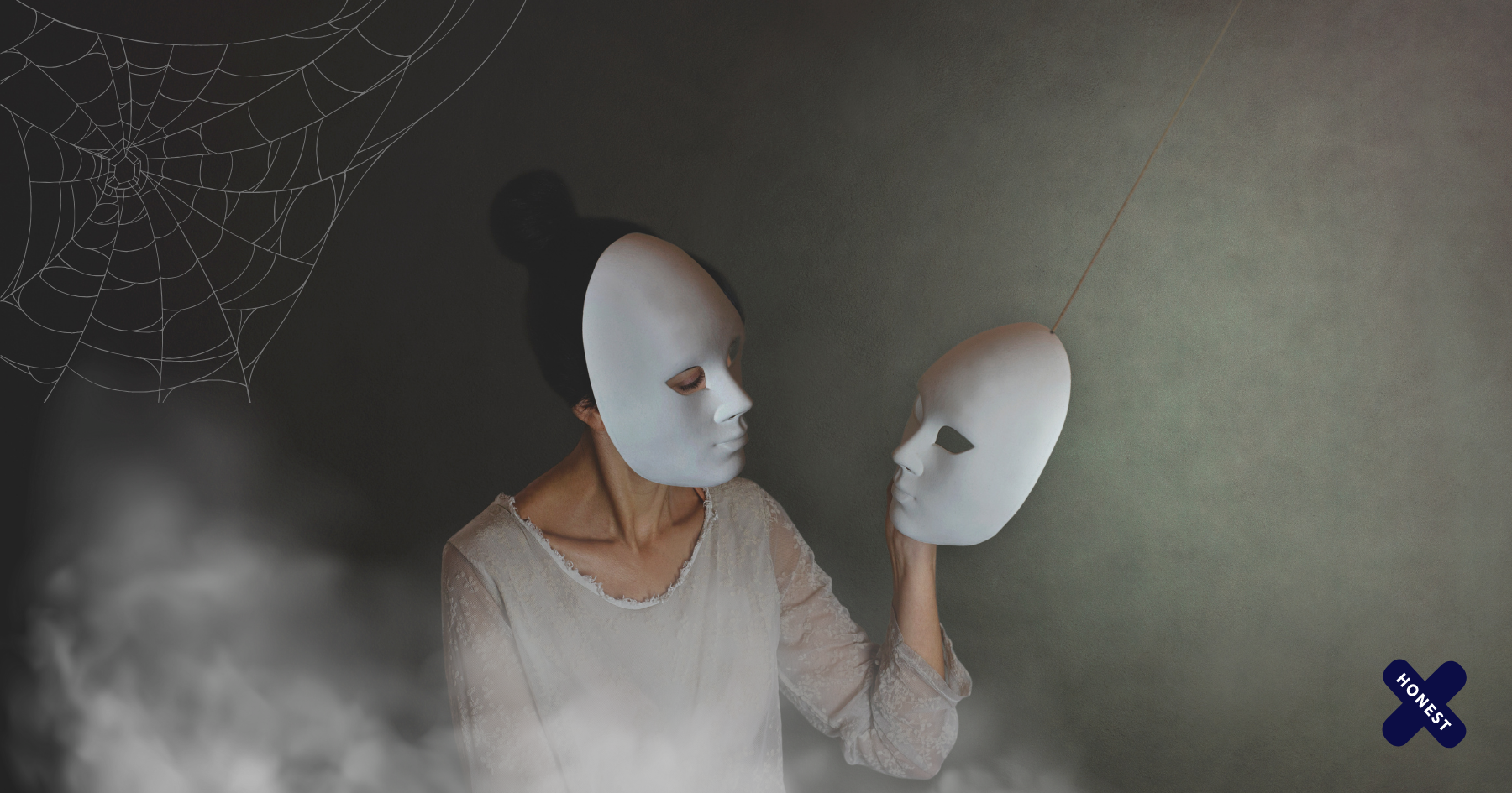 Picture of a woman wearing a white mask and a white dress and holding another mask