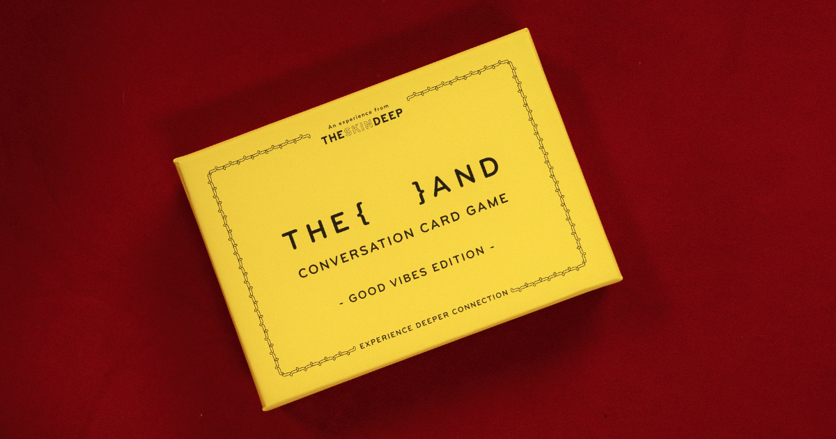Yellow box of {THE AND} Good Vibes Edition conversation card game on red background