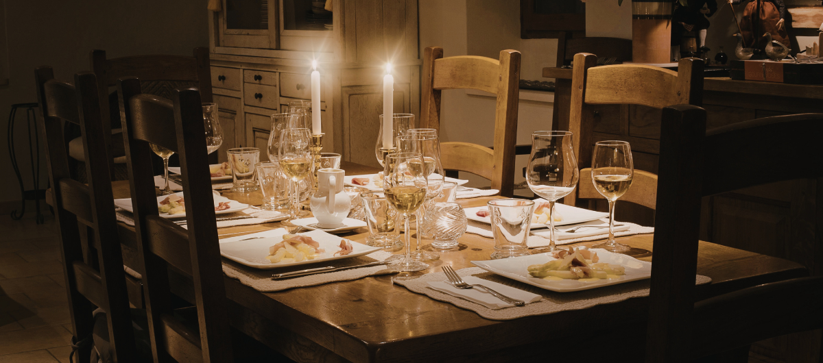 a table with well set dishware and candles