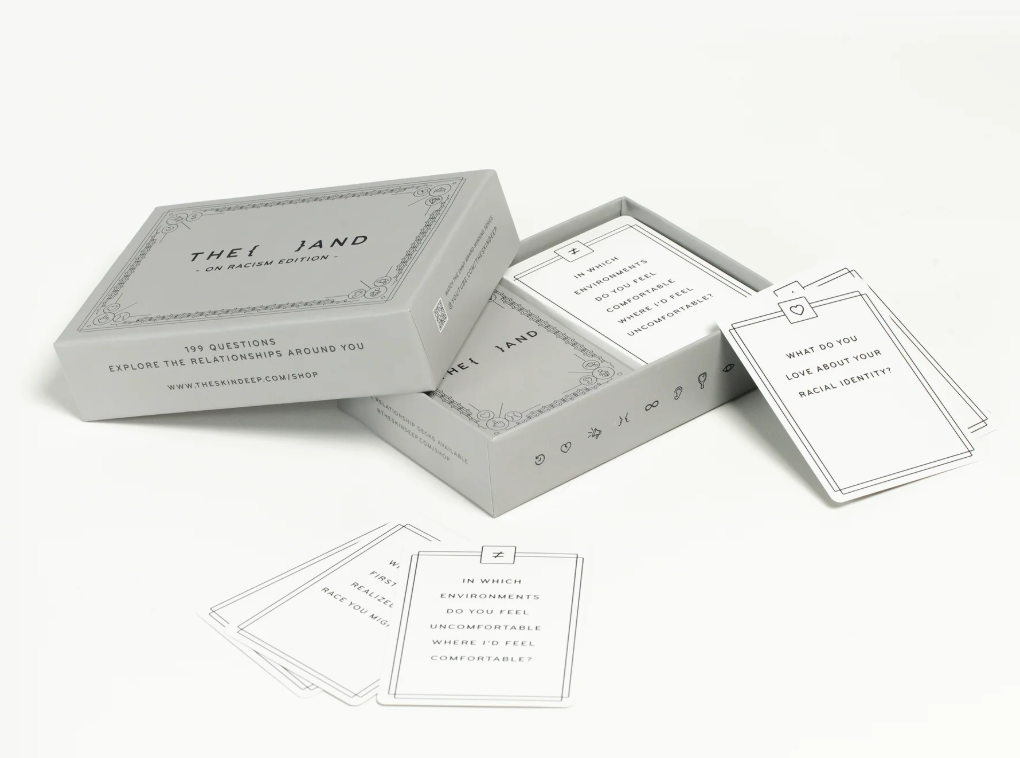 A box of cards with {THE AND} On Racism Edition written on them