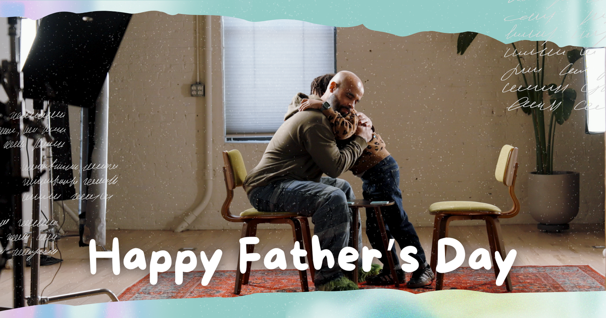 A picture of a dad and son hugging sitting face to face on Father's day