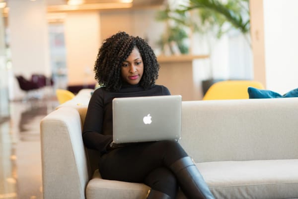 A woman works remotely on her laptop.