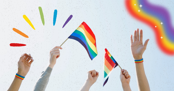 Picture of hands in the air waving a pride flag with a pride rainbow