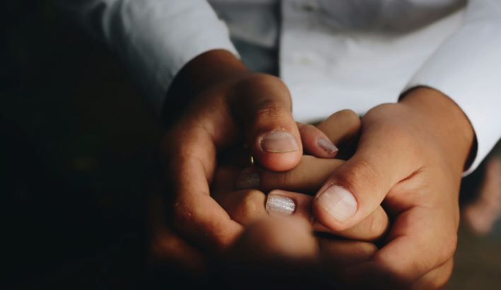 Two people holding hands