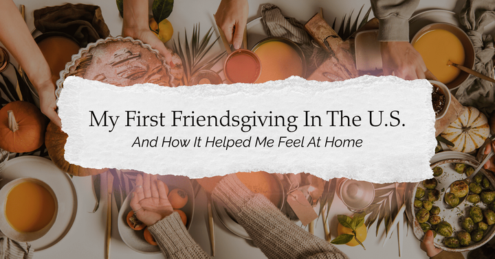 A Thanksgiving table with a lot of food for dinner and people making a toast and clashing their cups